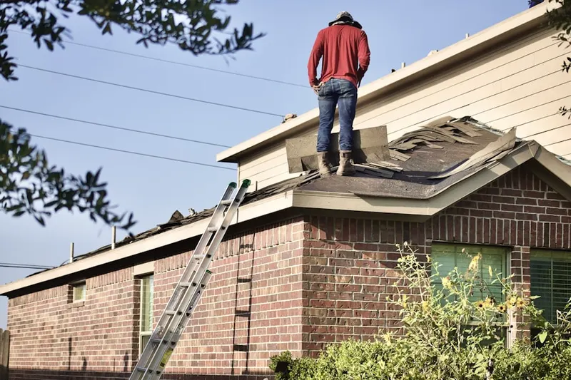 Professional roofer working on a residential roof in Historic Sandy